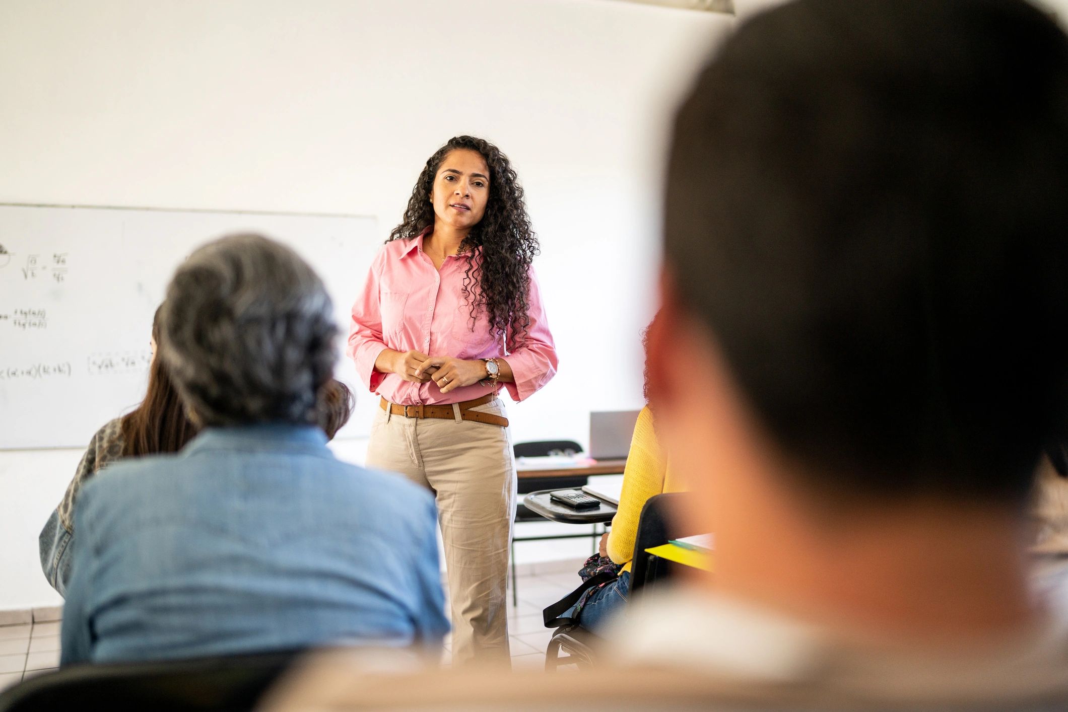 Instructor answering questions from students during a classroom session