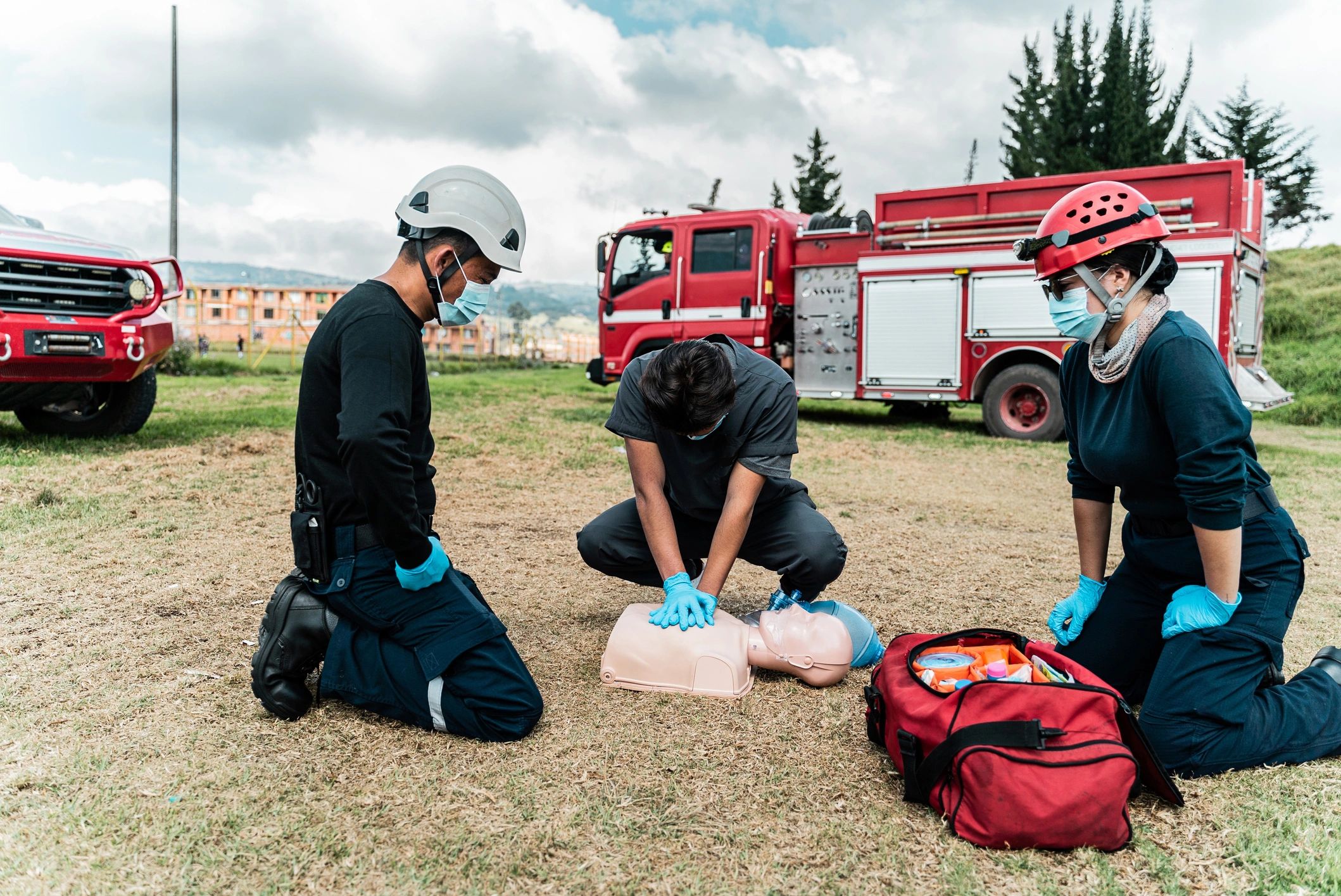 Man practicing CPR on a dummy during a class