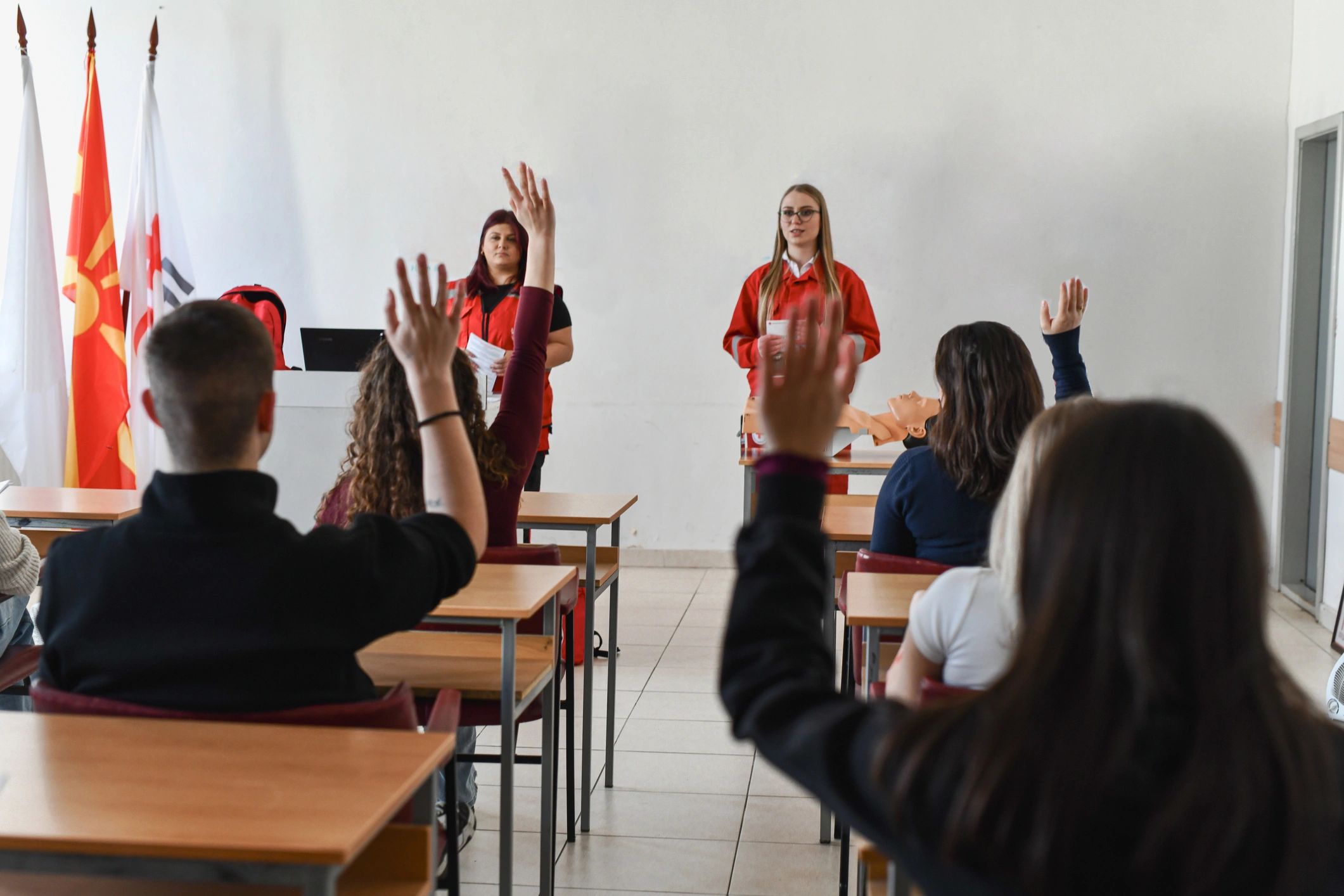 First aid training classroom with instructors and participant interaction