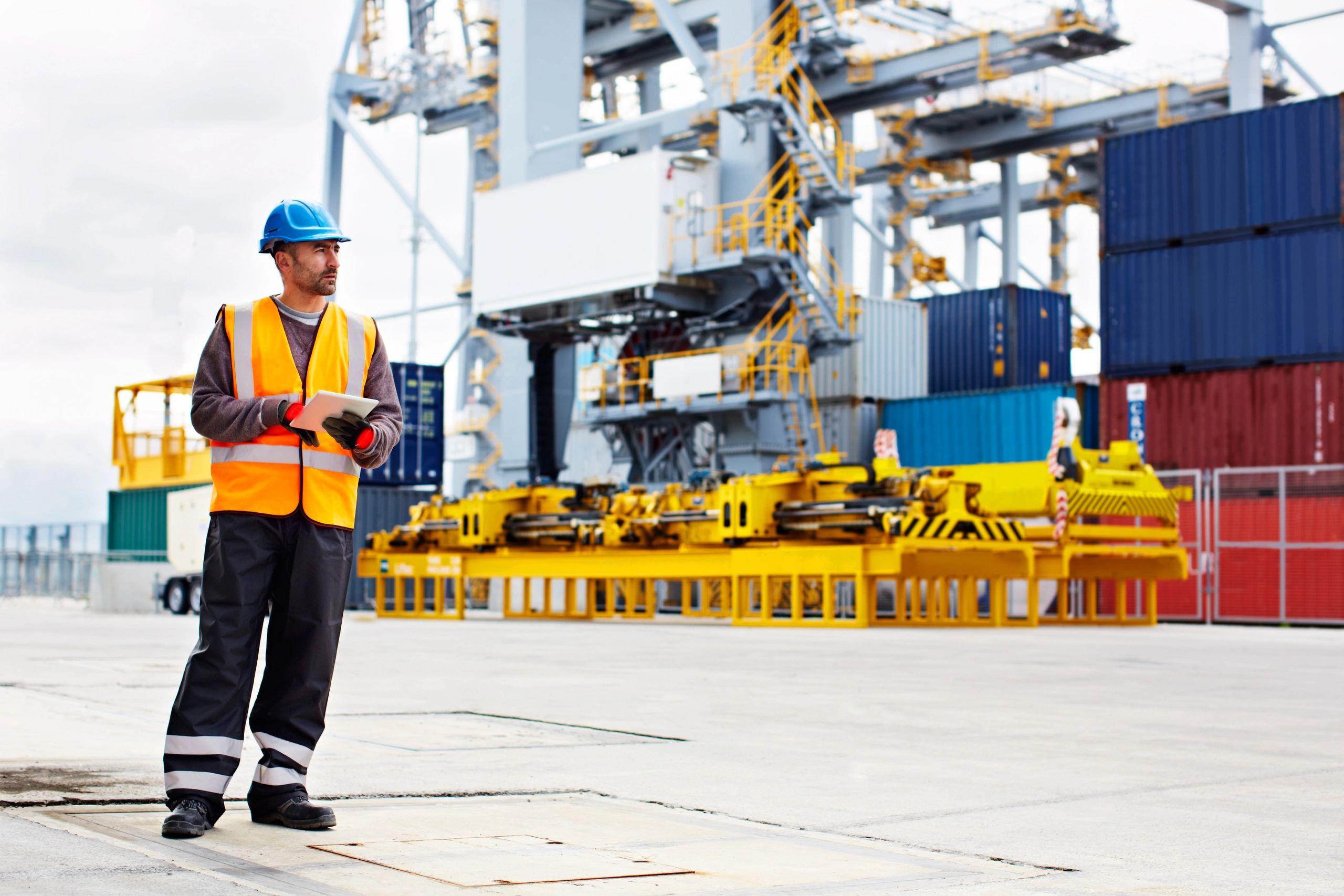 Worker using a tablet during an inspection on a commercial dock